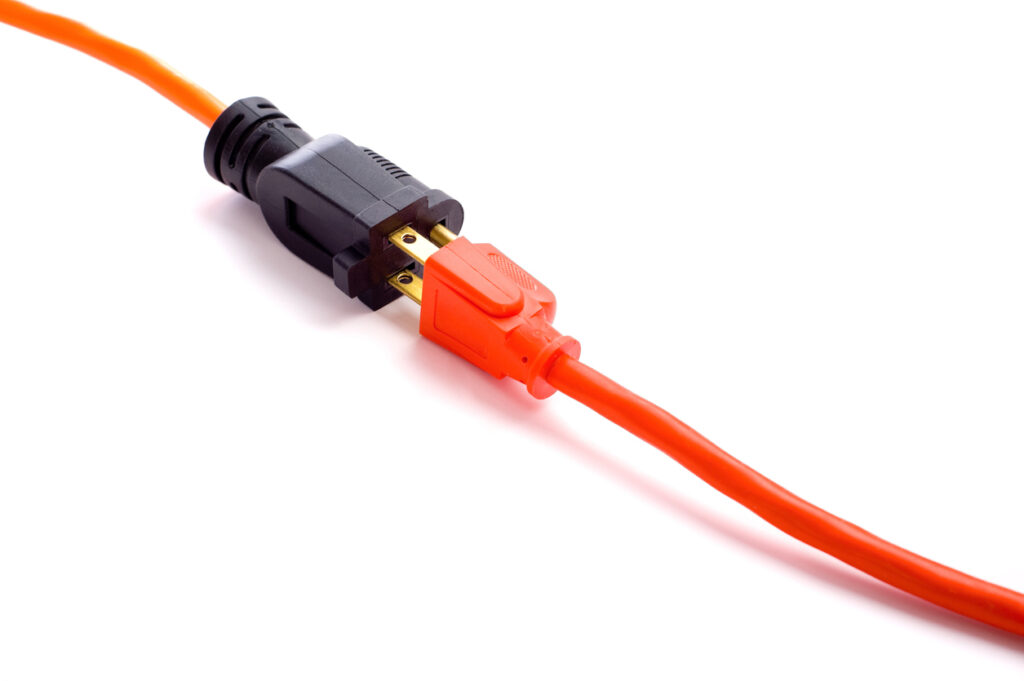 A new extension cord on a white background to indicate withdrawal or pulling out.