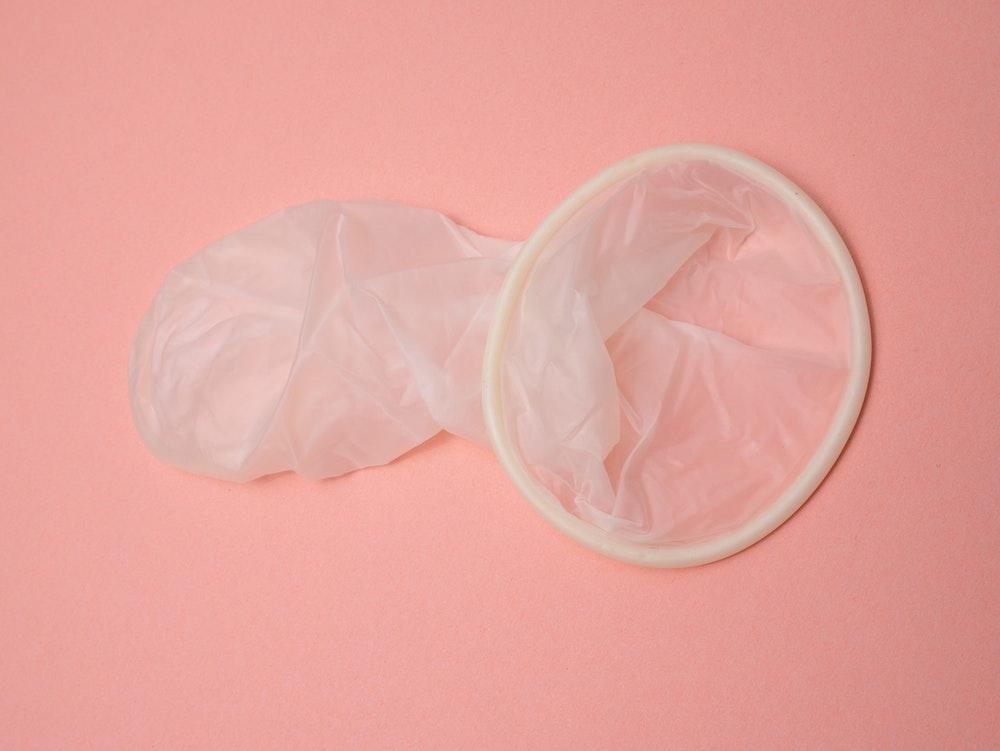 internal condom on pink background